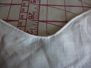 Tiny hem! You pretty much have to do this by hand. I don't think i could even get such a weeny little hem under the machine properly.