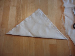Then, fold in half and sew (on a machine if you are me, by hand if you are crazy). Make sure that you go over the ends of the cord a couple of times, and that you leave a small hole for turning. I like to leave the hole about halfway down one of the sides, not on the corner, because that way your corners are nice and neat.
